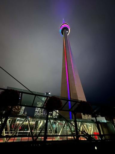 The striking CN Tower lights up the Toronto skyline by night.